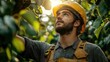 © Ala - Farmer in safety helmet examining fruit tree in orchard