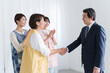 © polkadot - 握手する保育士と園長先生
