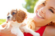 © peopleimages.com - Woman, happy and dog in park for love, pet care and excited for adoption approval. Person, puppy companion and smile in nature with support animal, new best friend and bonding for anxiety relief
