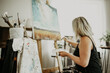 © peopleimages.com - Art, canvas on easel and painting, woman in studio at home with brush, creativity and inspiration with color. Paint, tools and talent, professional artist with ideas and freedom for creative work.