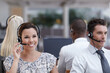 © peopleimages.com - Listening, call center and business woman with group at help desk for support, customer service or contact us. Smile, team and consultant with headset in office for debt collection, loan and finance