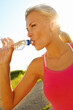 © peopleimages.com - Woman, fitness or drinking water with break for hydration, rest or recovery in countryside. Thirsty, female person or runner with mineral liquid or aqua bottle for natural sustainability or endurance