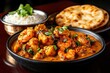 © Ranez - A Flavorful Indian Meal Flat Lay with Rice, Chicken, and Naan