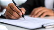 © Karen - Business professional signing contract with pen