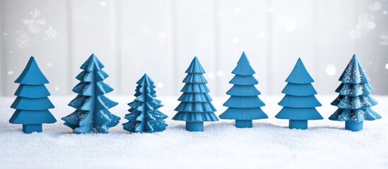 Aufkleber - Festive winter scene featuring blue wooden Christmas trees on a snowy background with ample copyspace for your seasonal message