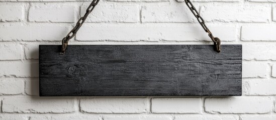 Aufkleber - Black wooden plaque hanging on chains against a white brick wall for interior design showcasing copyspace for text or decoration ideas
