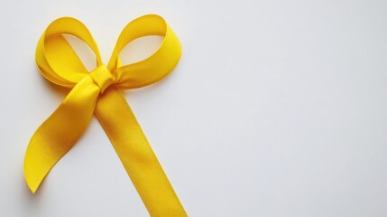 Wall Mural - Bright yellow ribbon bow elegantly arranged on a clean white background, perfect for gift wrapping and celebration themes.