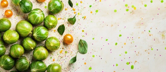 Wall Mural - Fresh Brussels sprouts and yellow cherry tomatoes with green leaves on textured surface decorated with colorful confetti and copy space.