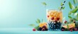© CreativeBro - Glass of bubble tea with assorted berries and fruits against blue background with copy space