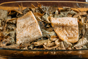 Wall Mural - Closeup on portion of baked white fish in a glass pan