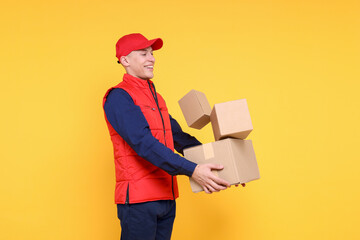 Poster - Happy postman with parcels on yellow background