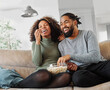 © Lumos sp - television watching couple tv home woman man remote movie entertainment sofa lifestyle sitting fun popcorn happy young smiling female happiness love leisure together
