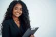 © Hunman - Confident young woman in business attire holding a clipboard and smiling on a white background.