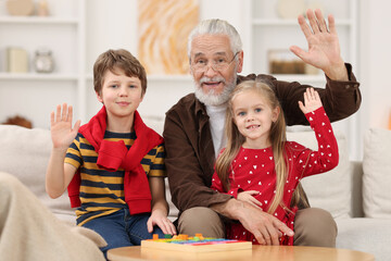 Wall Mural - Portrait of grandpa and his grandkids at home