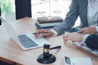 © Kritdanai - Legal Consultation: A close-up image of a lawyer and client engaged in a confidential legal consultation, emphasizing professionalism and trust.