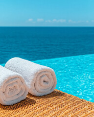 Poster - A cinematic close-up focusing on neatly rolled towels placed on wicker loungers, while a tranquil blue pool stretches out in the distance,