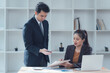 © Nittaya - Business Collaboration:  A professional setting showcasing a focused meeting between a male and female colleague, emphasizing teamwork, communication, and collaborative problem-solving.