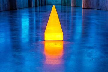 Poster - An elegant composition highlighting the subtle reflection of the blue UV tube on a polished metallic floor, accentuating the glowing filament,