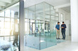 © peopleimages.com - Corporate, office and business people on tablet for meeting, collaboration and teamwork. Workplace lobby, professional and men on digital tech for internet, research and discussion for online project