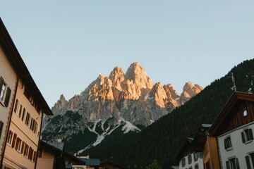 Wall Mural - Majestic Mountain Peak Overlooking Alpine Village Houses