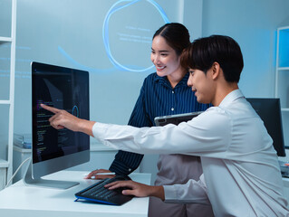 asian two software developer working on computer in office, planning and collaboration on their proj