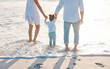 © peopleimages.com - Beach, mother and father with child for holding hands, travel holiday and bonding together outdoor. Parents, mom and dad with girl for family relationship, support and vacation experience on ocean