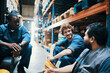 © Davor - Warehouse workers taking a break sitting near forklift in storage facility
