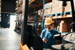 © Davor - Smiling male warehouse worker using smartphone near forklift