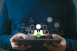 © Bordinthorn - A person holding a tablet with digital icons representing team selection, recruitment, or HR management. Concept of business technology.