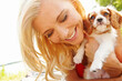 © peopleimages.com - Happy woman, relax and puppy in park with hug, pet care and smile for adoption approval. Person, dog companion and excited in nature with support animal, new best friend or bonding for anxiety relief
