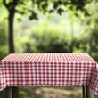 © Angelina - A bare wooden table with a tablecloth on it in a blurred bokeh setting