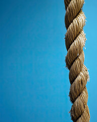 Poster - Close-up of a Tightly Knotted Rope With an Artistic Backdrop Creating a Striking Visual Contrast