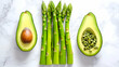 © lena - Vibrant green asparagus stands tall beside sliced avocados, highlighting a fresh culinary delight