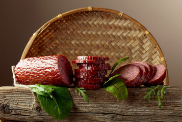 Wall Mural - Sliced salami on a old wooden board.