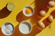 © wernerimages - An overhead view of cooking ingredients, including eggs and lime, displayed on a bright yellow surface, evoking a sense of warmth and culinary creativity.