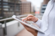 © peopleimages.com - Hands, online and person with tablet, balcony and planning for financial report, accountant and outdoor. Business, reading and auditor with app for records, information and data collection for tax
