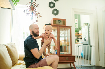 Sticker - Baby, father and playing airplane in air on the sofa in a home living room for fun, love and care. Male person or dad with a child for quality time, bonding and happiness while together in the lounge