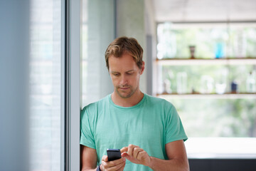 Home, man and scroll with smartphone for social media, connection and online text with contact. House, male person and notification with mobile app for communication, reading comment and web chat