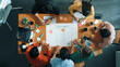 © Summit Art Creations - Top down aerial view of business team making scrum task board at meeting room. Group of people writing at paper and sticky notes for making kanban board to manage work flow. Top view. Convocation.