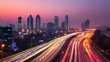 © NAIMAH - City highway sunset traffic light trails, urban skyline background, advertising