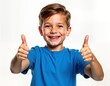 © miss irine - Cheerful boy gives thumbs up gesture. Smiling kid shows agreement. Portrait of happy child in casual attire. Positive expression. Isolated on plain white background. Good choice for kid-related