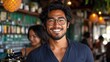 © Muhammad - Smiling man at bar counter.