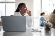 © peopleimages.com - Headset, laughing or black woman on laptop for customer service, online help or business loan. Smile, financial consultant or funny agent in agency for insurance call center support or communication