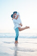 © peopleimages.com - Couple, hug and lift at beach, love and vacation for connection in low angle, care or bonding in summer. People, man and woman in embrace, outdoor and profile with eyes closed on holiday in Indonesia