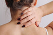 © Paweł Michałowski - Woman suffering from neck pain holding the back of her neck. Upper back discomfort. Muscle tension and rehabilitation concept. Health problem related to posture, stress, or injury recovery.