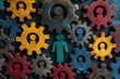 © RizArt - Colorful gears with person icons represent teamwork and collaboration