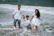 © alexkoral - happy family with a child son playing on the beach in the sea on summer vacation