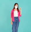 © sitthiphong - Portrait of confident Asian businesswoman casual pink shirt and shows ok sign with disposable face mask isolated in blue background, Protection versus viruses and infection concept.