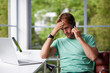 © peopleimages.com - Thinking, phone call or man in home with stress, worry and bad news on mobile conversation. Listening, doubt or person on laptop with bankruptcy, financial loss or debt crisis with online mistake