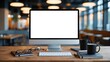 © sukarman - desktop computer monitor with a blank white screen on a wooden desk. The monitor is placed in the center of the desk and is facing towards the right side of the image.